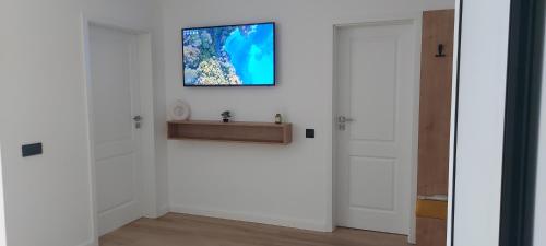 a room with two doors and a television on the wall at SIA Studio in Oradea