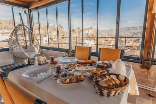 a table with food on it with a view of the city at Zula Cave House in Urgup