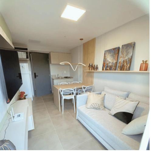 a living room with a couch and a table at Lindo Apartamento no Centro de Porto de Galinhas in Porto De Galinhas