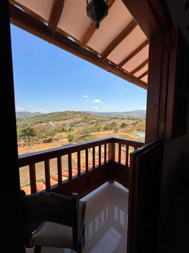a room with a balcony with a view of the mountains at Hotel Palais Barichara in Barichara