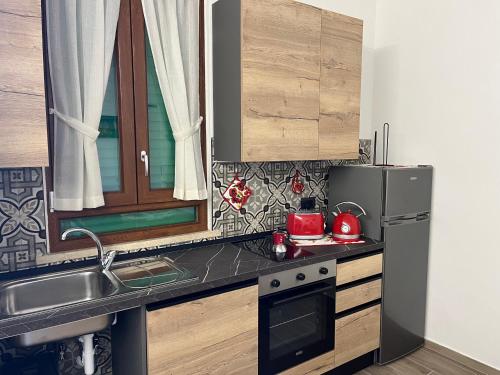 a small kitchen with a sink and a refrigerator at La Casina di Cinzia in San Gimignano