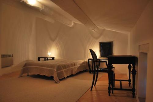 a bedroom with a bed and a desk and a piano at Mas 20 personnes en Drôme provençale, région de Nyons in Chaudebonne