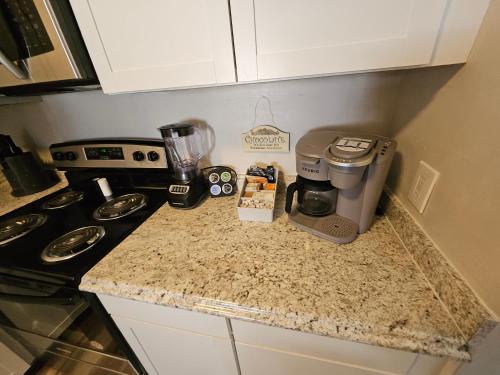 a kitchen counter with a coffee maker and a blender at Spacious 3 bedroom Condo Close to Weirs Beach!! in Laconia