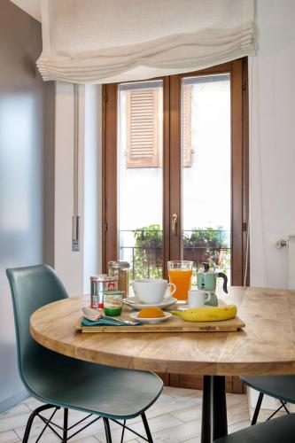 a wooden table with a plate of food on it at Ballatoio Apartment by the Lake in Lesa