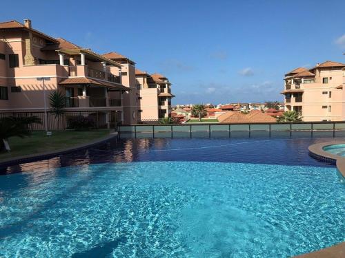 a large swimming pool in front of some buildings at Apto. Beverlly Hills, Próx. Beach Park in Aquiraz
