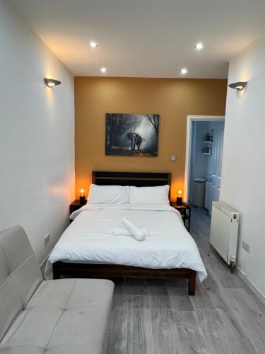 a bedroom with a large bed and a couch at Studio in Camden, King's Cross in London
