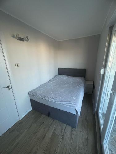 a small bedroom with a bed in a room at Viewpoint in Belgrade
