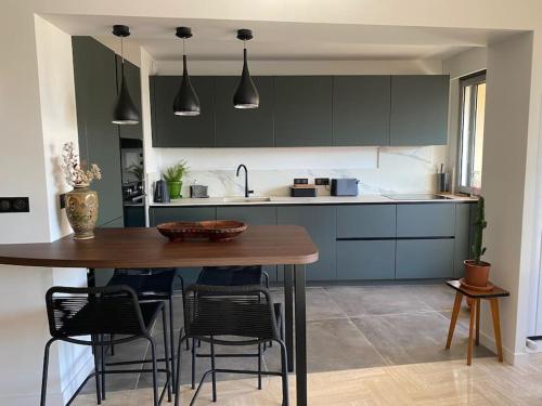 une cuisine avec une table en bois et quelques chaises dans l'établissement Appartement Marina, à Mandelieu-la-Napoule
