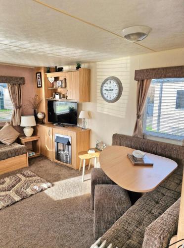 a living room with a couch and a table at 35 Irby way in Lincolnshire