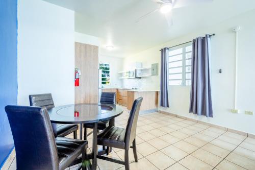 a kitchen and dining room with a table and chairs at West Coast Inn's in Boqueron
