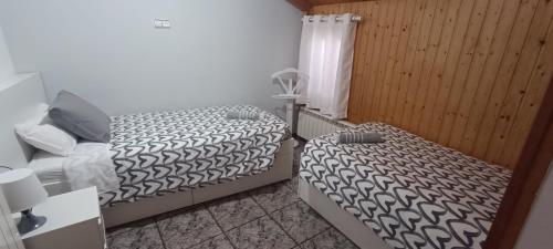 a bedroom with two beds and a window at Masia La Roca in Castellnou de Bages