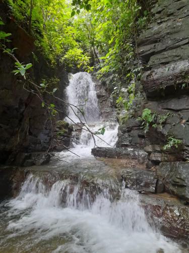 a waterfall in the middle of a river at Tinamaste in Uvita