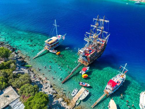 two large boats are docked in the water at Sunlight Otel Fethiye in Fethiye