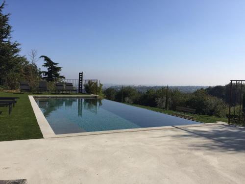 a swimming pool with a view of the mountains at Maison de famille in Chaponost