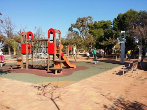 a playground with a slide in a park at Apartamento El Faro playa Nules in Castellón de la Plana
