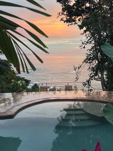 a swimming pool with a view of the ocean at Veranera in Uvita