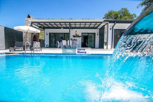 a water fountain in front of a house at Tam korunaklı villa 'Kayaköy' in Fethiye