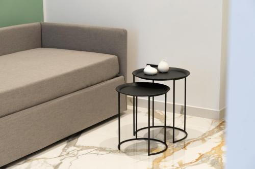 a living room with two tables next to a couch at InSogno Suites in Naples