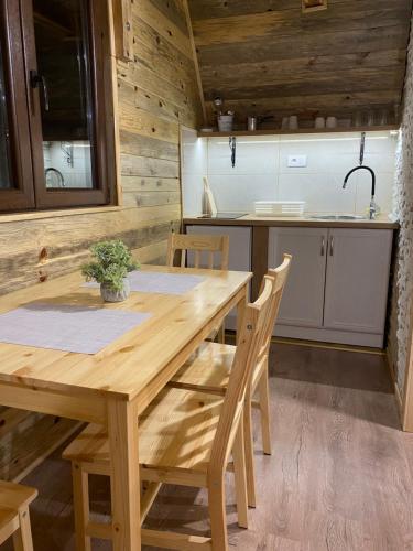 a wooden table and chairs in a kitchen at BRVNARE DJOKIĆ in Ðokici