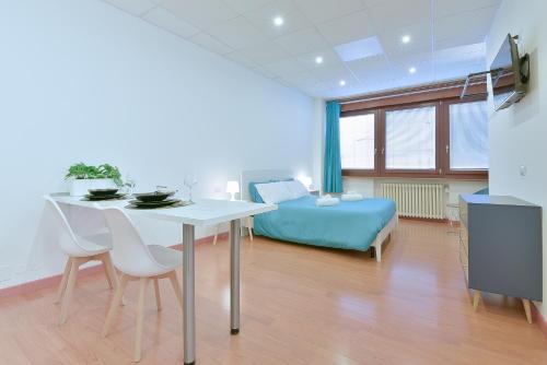 a room with a bed and a table and chairs at LHE Les Trois Merveilles in Cesena