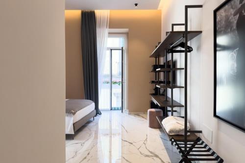 a living room with a bed and a television at InSogno Suites in Naples
