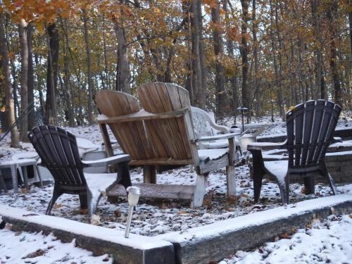 a group of three chairs in the snow at Serenity Hill Bed and Breakfast in Sloans Crossing
