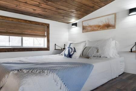 a bedroom with a large white bed in a room at Life's a Beach - 3 Acres with Hot Tub in Fredericksburg