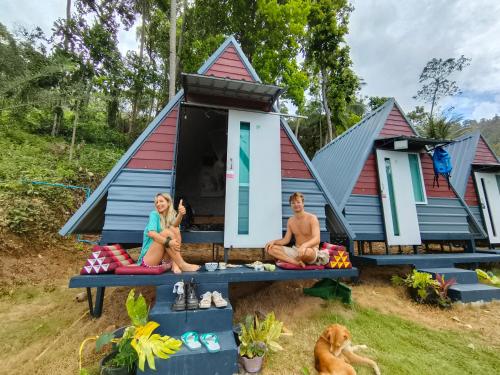 a group of people sitting in front of a tiny house at SZ Samui Glamping in Ban Sa Ket