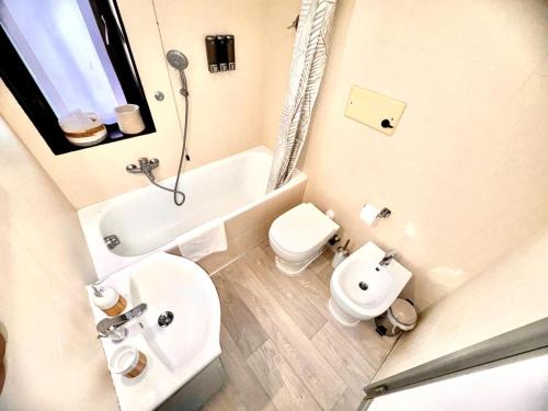 a white bathroom with a sink and a toilet at Nice Turin 26 - Porta Nuova - Metro Marconi in Turin