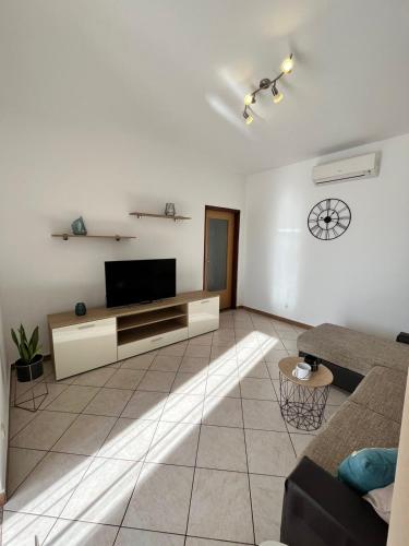 a living room with a television and a couch at Darlen in Rabac