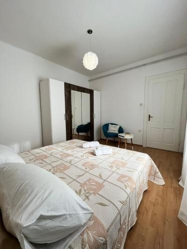a white bedroom with a large bed in it at Darlen in Rabac