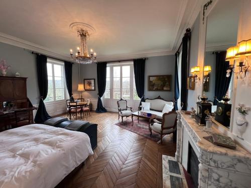 a bedroom with a bed and a living room at Chateau du Gue aux Biches in Bagnoles de l'Orne