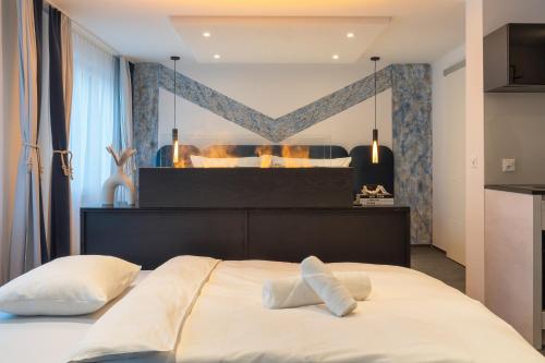 a bedroom with a large bed with a large mirror at LOFT am See - dein Zuhause direkt am Wasser - self checkin - Bitcoin accepted in Thun