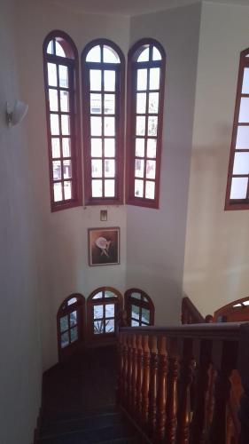 a group of windows in a building with a staircase at Pousada Castelinho Conservatória in Conservatória