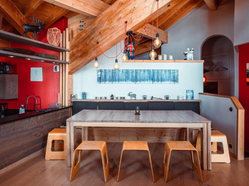 a kitchen with a large wooden table and two stools at Superbe chalet 5 chambres avec cheminée et accès privatif à Avoriaz - FR-1-314-161 in Morzine