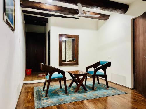 a dining room with two chairs and a table at Main Street Inn in Srinagar