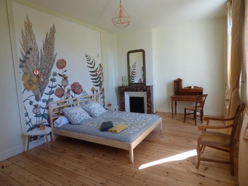 a bedroom with a bed in a room with a fireplace at Chateau Magondeau in Saillans