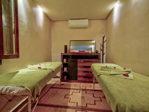a hospital room with two beds and a mirror at Riad Maialou & SPA in Marrakech