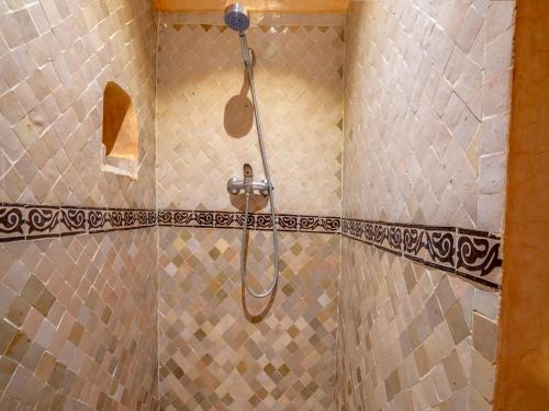 a shower with a shower head in a bathroom at Riad Maialou & SPA in Marrakech