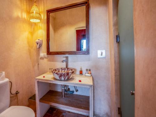 a bathroom with a sink and a mirror and a toilet at Riad Maialou & SPA in Marrakech