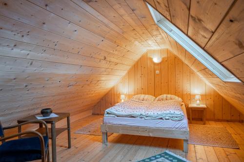a bedroom with a bed in a wooden attic at Górski Sad - Bazylia in Piechowice