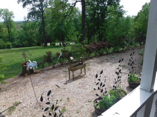 a garden with plants and flowers in a yard at Serenity Hill Bed and Breakfast in Sloans Crossing