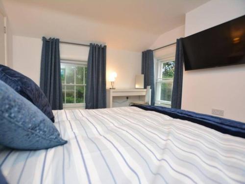 a bedroom with a large bed with blue pillows at Welcoming luxury in a Grade II listed building in Chester