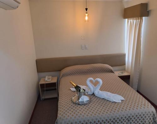 a room with a bed with two swans on it at Hotel Melodia in Lima