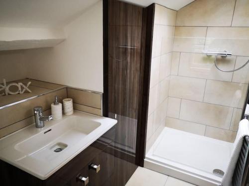 a bathroom with a sink and a shower at Welcoming luxury in a Grade II listed building in Chester