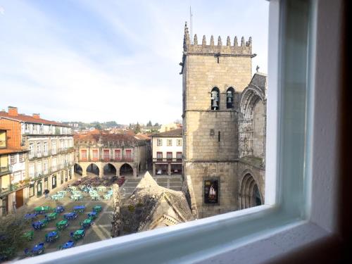 a view from a window of a building with a church at Aparthotel Largo da Oliveira in Guimarães