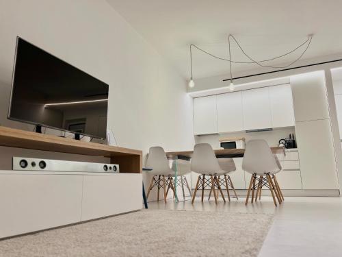 a kitchen with white cabinets and a table and chairs at GINNY HOUSE VENEZIA in Dolo