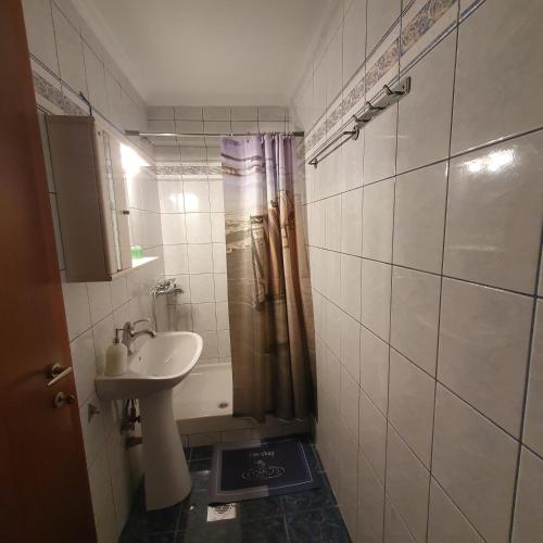a bathroom with a sink and a shower at Xrisa's house in Kavala