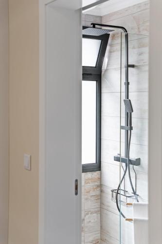 a shower in a bathroom with a glass door at Blue Ocean Villa in Ponta do Sol