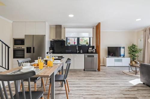 a kitchen and living room with a table and chairs at Blue Ocean Villa in Ponta do Sol